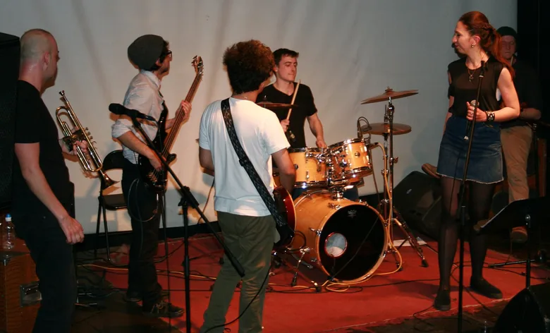 A band on a small stage — trumpet, bass, guitar and a singer, with me behind the kit